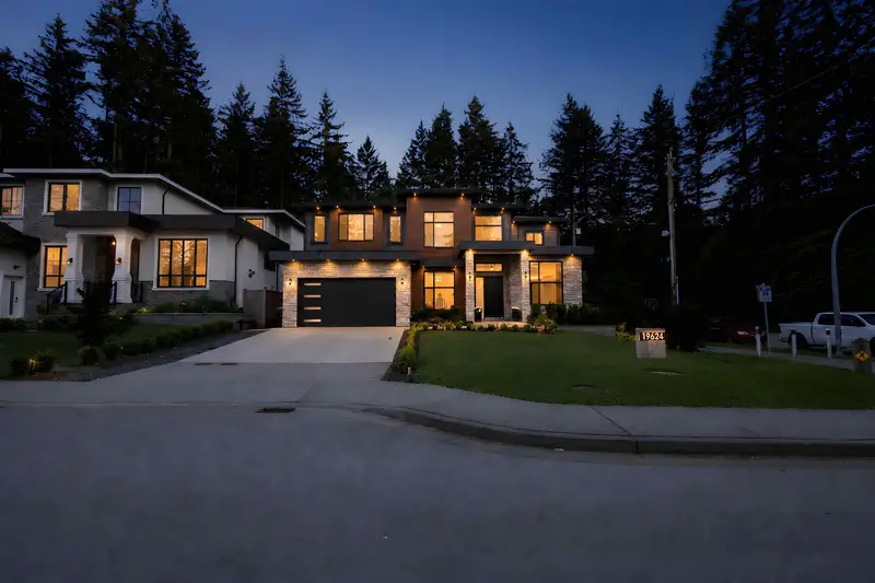 Front street-view exterior of a modern Langley detached home at dusk