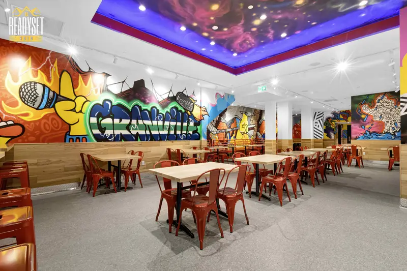 Dave's Hot Chicken colourful dining area with Granville graffiti mural in Vancouver