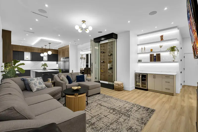 Open living room with wine display and built-in bar in a Langley luxury home