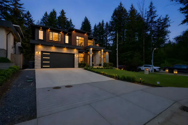 Twilight exterior with warm lighting on a Langley luxury detached home