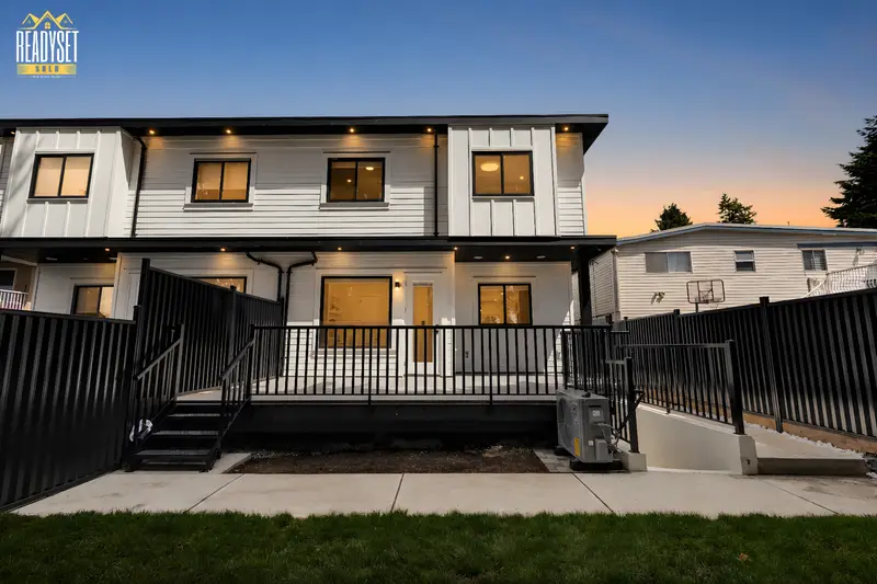 Virtual twilight rear exterior with deck and yard at 7143 W Brewster Street, North Delta